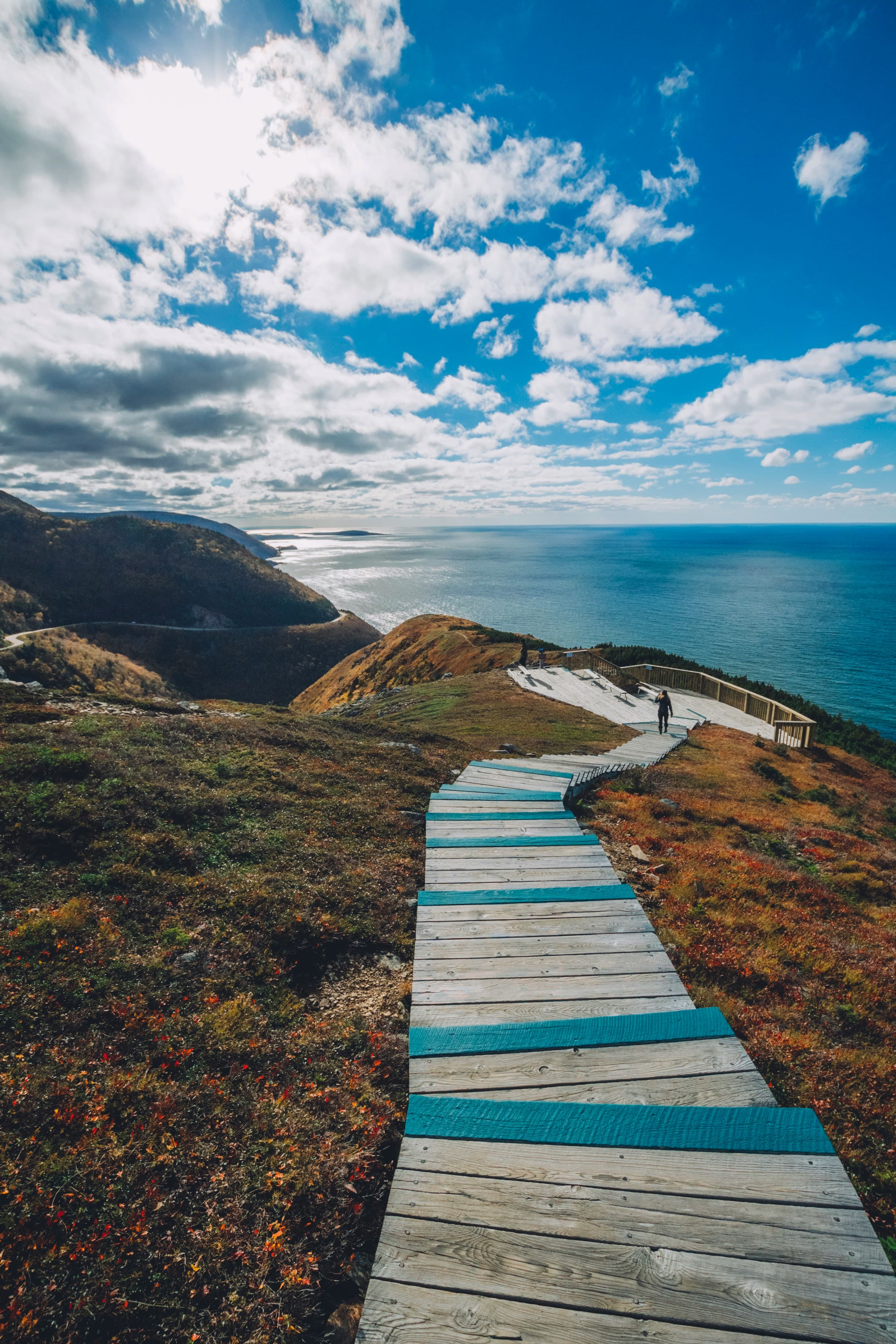 Photograph of the Skyline Trail in Cape Breton; a series of wooden stairs atop a cliff with a view of the ocean.